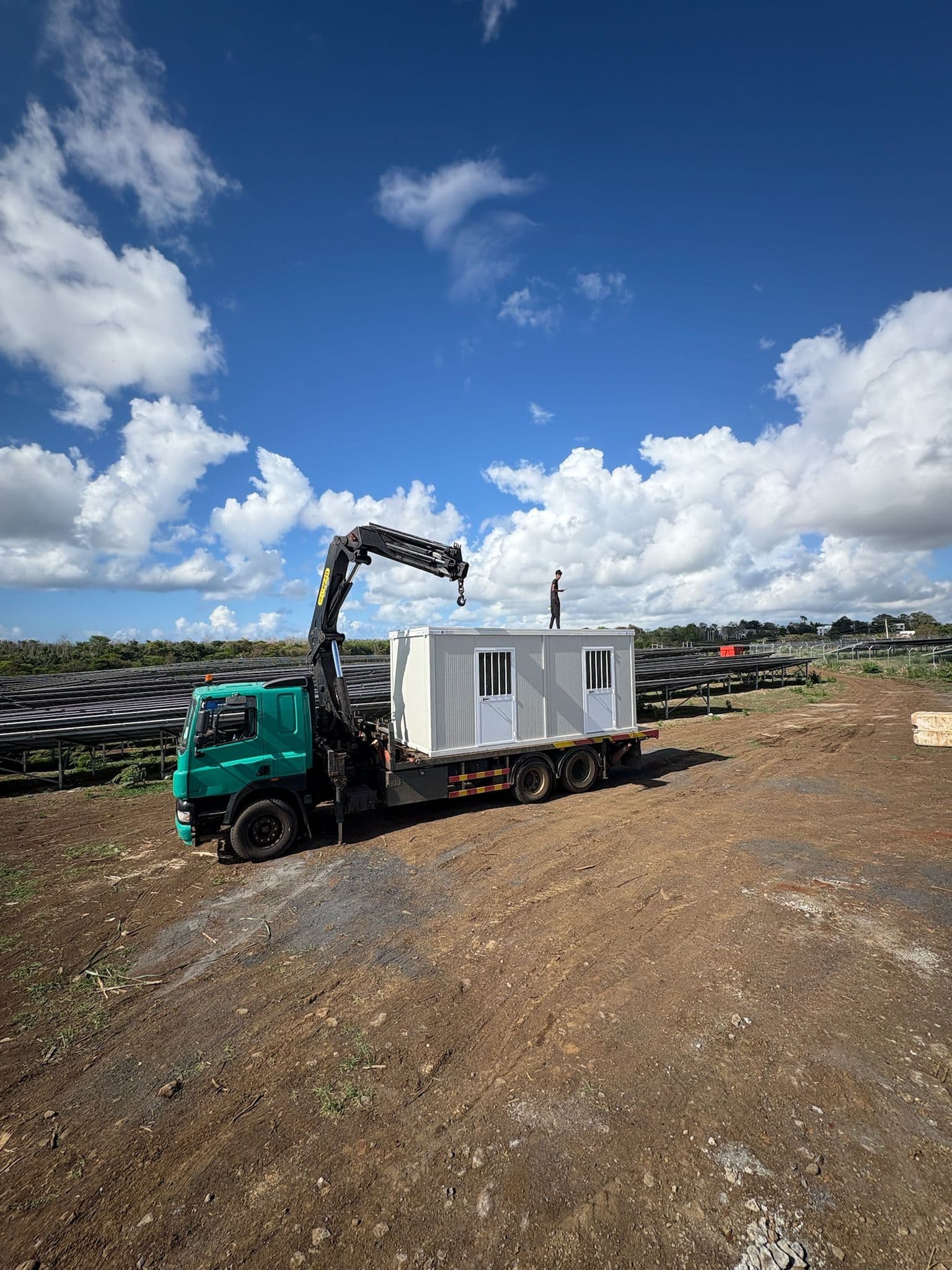 Crane installation of a prefabricated modular unit on an outdoor site